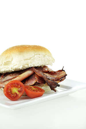 Danish smoked bacon roll shot against a white background with generous accommodation for copy space.の写真素材