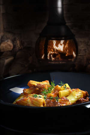 Bolognese pasta bake shot against a rustic, dark background with generous accommodation for copy space.の写真素材