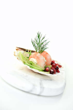 Fresh Tiger Prawn canapes with whipped cream cheese, dill and pomegranate garnish shot against a...