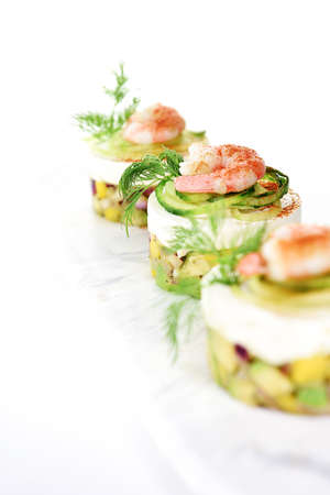 Mango, Avocado and Prawn Canapes shot against a white background with accommodation for copy space.の写真素材