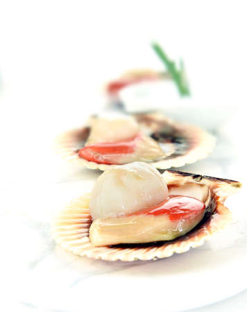 Prepared uncooked King Scallops ready for cooking with orange roe (coral) attached. Concept image for food preparation, hygiene etc. Generous accommodation for copy space.の写真素材