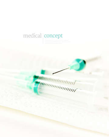 Modern, clinically clean, medical concept image with generous accommodation for copy space. Generic, sterile, plastic syringes with the critical focus on the tip of the needle.の写真素材