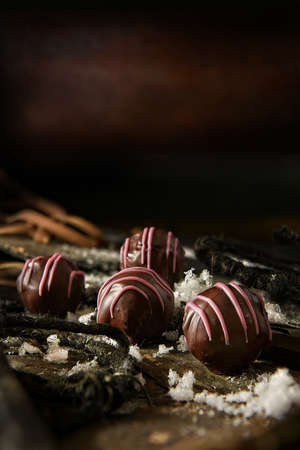 Dark winter festive styled image of dark liqueur chocolates with generous accommodation for copy...