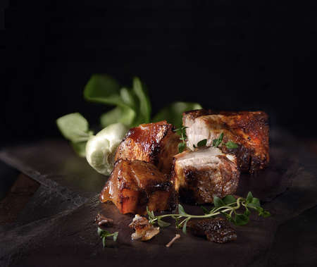 Chinese style roasted pork bellies ready for serving with Pak Choi and thyme herb garnish. The perfect image for your Chinese New Year menu or promotion designs.の写真素材