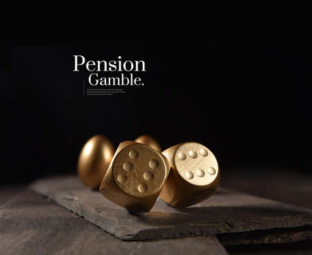 New and unique concept image created to represent pension and investments risks. Creatively lit image of two tumbling dice and gold pension eggs against a black background with copy space.の写真素材