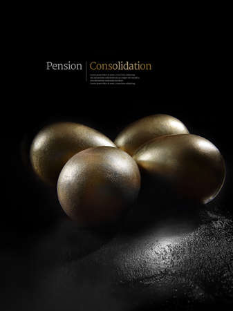 Concept image for pension investments, consolidatyion and savings. Gold painted eggs shot against a black background with generous copy space. Illustrative text can easily be removed.の写真素材
