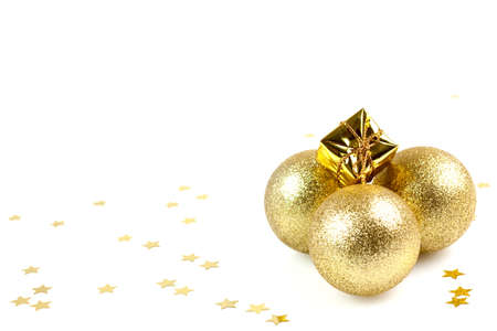 golden christmas balls and present with copy space isolated on whiteの写真素材