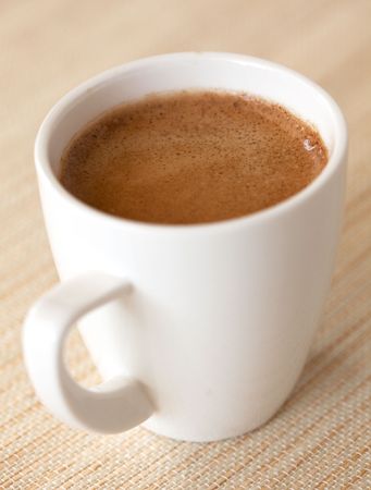 white coffee cup on brown tableの写真素材