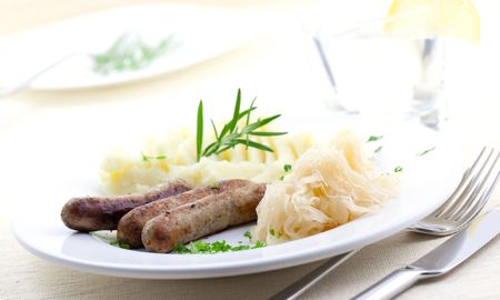 lunch with fried sausage sauerkraut and potatoesの写真素材
