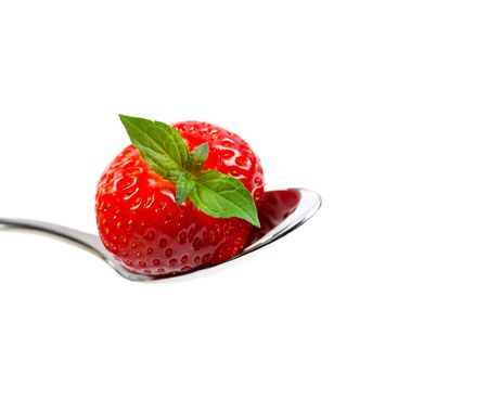 strawberry on spoon isolated on whiteの写真素材