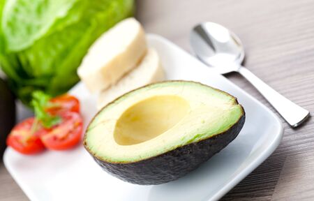 half of avocado on plate の写真素材