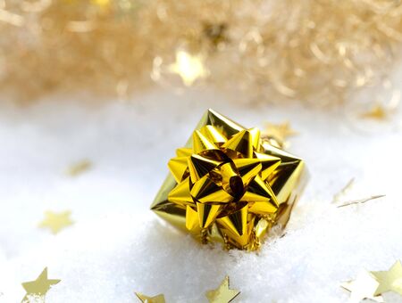 golden gift in snow with stars の写真素材