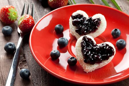two toast hearts with fresh bilberry jam の写真素材