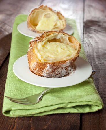 sliced cream puffs filled with pudding の写真素材