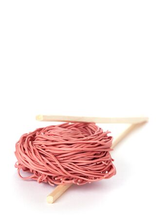 red noodles and chopsticks isolated on white background の写真素材