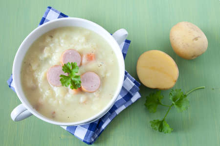 fresh potato soup with sausages の写真素材