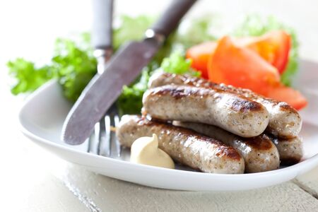 fresh grilled sausages with salad on plate の写真素材