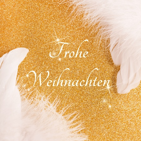 christmas card with wings and german frohe Weihnachtenの写真素材