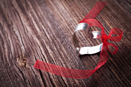 heart with bow on brown wood with copy space の写真素材