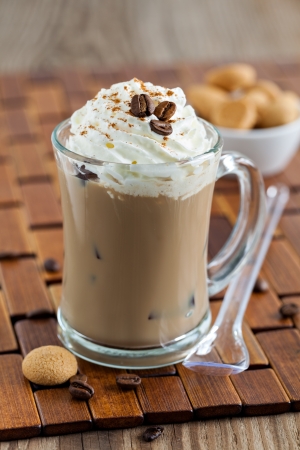 A cup of coffee or hot chocolate and female feet with socks on.. A cup of coffee or hot chocolate and female feet with socks on..