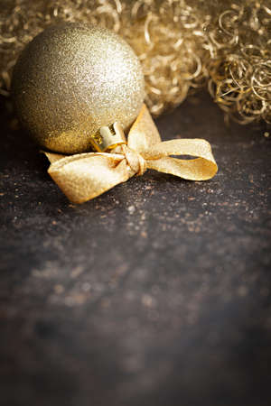 golden christmas bauble with ribbon and copy space  の写真素材