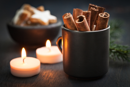 cinnamon sticks and cookies on wooden backgroundの写真素材