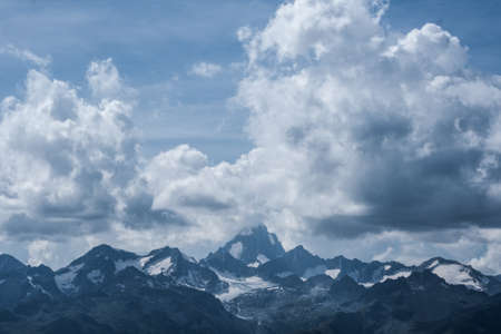 View of a mountain in Switzerland surrounded by clouds.