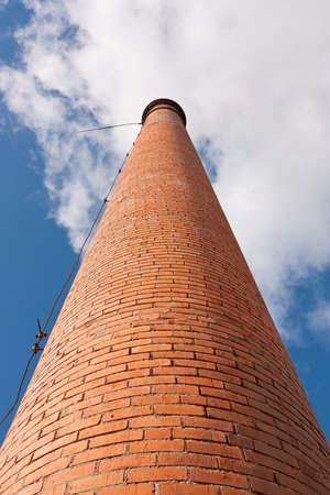 Industrial Old Brick Chimney without smoke, on blue skyの写真素材