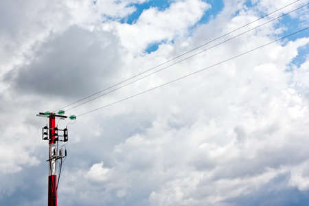 Red & White Medium Voltage Pylon against cloudscape.の写真素材