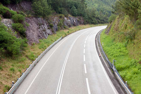 Above view of a empty highway through mountainsの写真素材