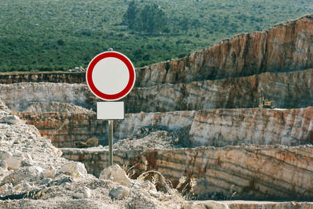 No thoroughfare sign with an open quarry behindの写真素材