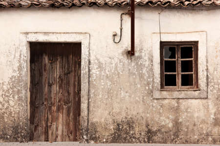 Low color version of old abandoned facade in Portugalの写真素材