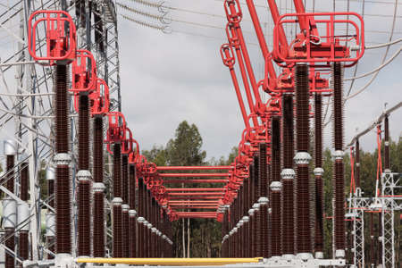 Part of High Voltage Station connectors against sky and woods