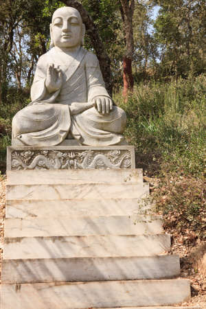 Marble buddha statue exhibited in an public gardenの写真素材