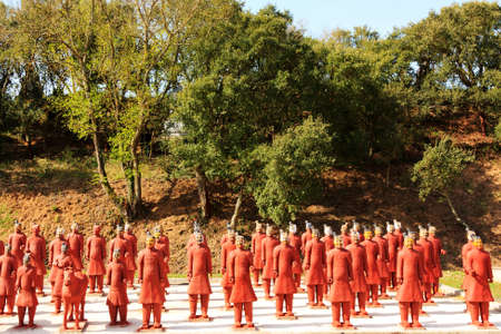 Several red terracotta soldiers exhibited in an public gardenのeditorial素材
