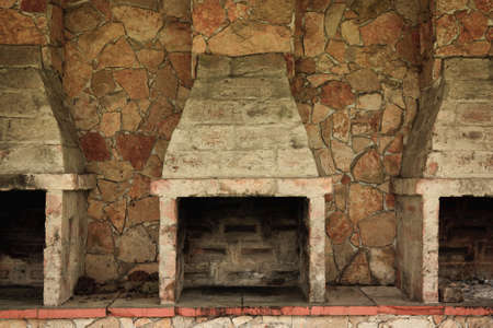 Empty and Fireless brick ovens against stone wallの写真素材