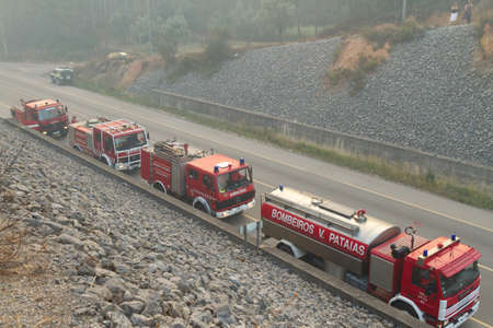 POMBAL, PORTUGAL - JULY 15: Fire Trucks on a road to prevent that wildfire crosses the road, in Pombal, Portugal on July 15, 2012のeditorial素材