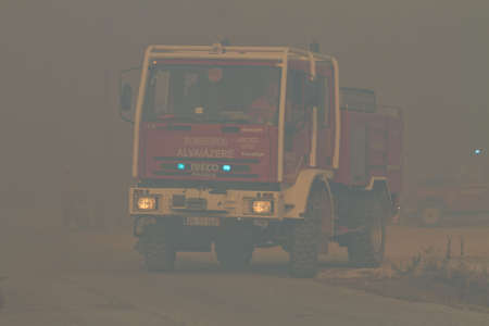 POMBAL, PORTUGAL - SEPTEMBER 22: Fire Truck changing position on Wildfire, in Pombal, Portugal on Setember 22, 2012のeditorial素材