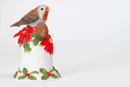 Small statue of an bird on top of a bell