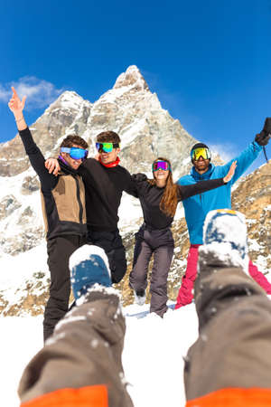 Happy People Group in Ski Equipment, Hugging Together, Looking at camera, Have Ski Resort Snow Winter Mountain.の写真素材