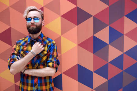 T-shirt with a pair of fashionable clothes on the summer day. Stylish handsome guy. Portrait of a man's face.の写真素材