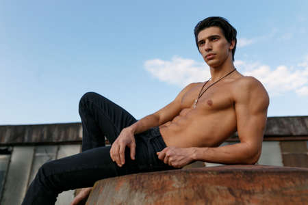 Horizontal portrait of handsome muscular and sexy athlete young man with naked torso.