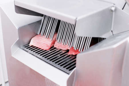 Fresh, raw cuts of minced meat, introduced into an introductory washing in the meat production process. Meat company, industry foods.の写真素材