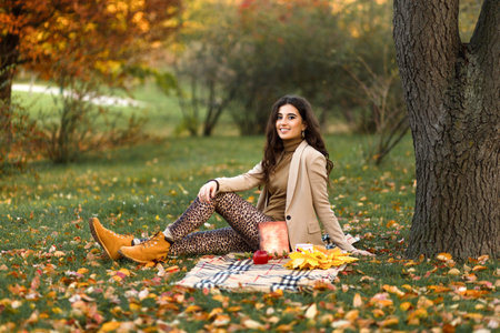 Beautiful caucasian girl on the nature picnic with fruits. Relaxing young woman in Nature. Autumn...