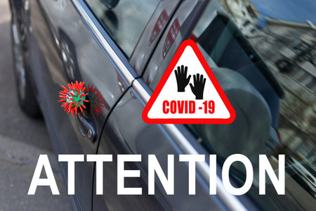 Red headline with inscription COVID-19 on white triangle with virus strain model sitting on the door...