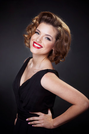 Closeup portrait of a elegant, smiling young woman, model with charming hairstyle and make up, over...