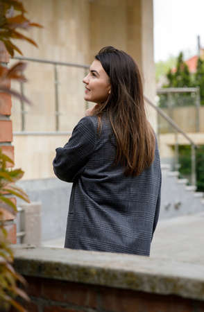 the young girl walks around the city, posing from behind.の写真素材