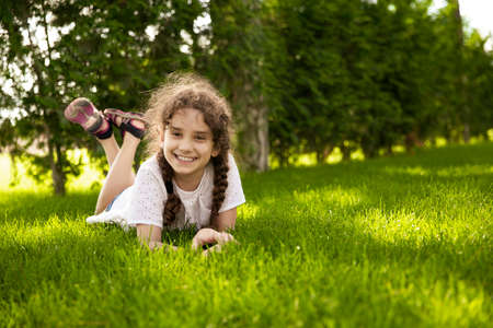 Happy adorable little girl having fun at the parkの写真素材