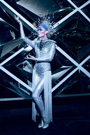 Full length image of a young woman with creative makeup and hairdresser wearing futuristic costume.の写真素材