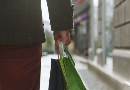 Closeup of man holding shopping bagsの写真素材